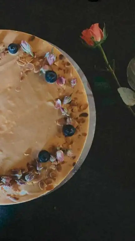 Torte mit Karamell, Blaubeeren und Rosen von oben